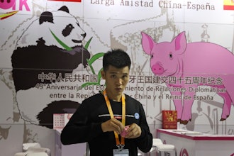 A promoter at a booth for imported Spanish pork prepares for another day at the China International Import Expo in Shanghai.