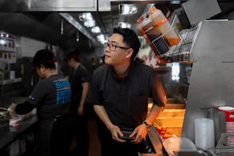 Lawrence Cheng, whose family owns seven Wendy's locations south of Los Angeles, works in the kitchen at his Wendy's restaurant in Fountain Valley, Calif.