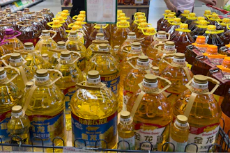 Shoppers pass by cooking oil products at a supermarket in Beijing.