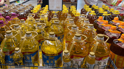Shoppers pass by cooking oil products at a supermarket in Beijing.