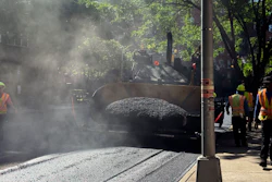 A road crew repaves a road in the Forest Hills neighborhood in the Queens borough of New York.