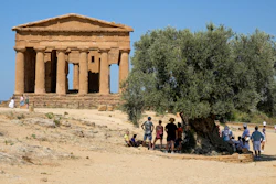 Visitors admire the ancient Greek Concordia temple, known as the Temple of Juno, in the Valley of the Temples archeological park, Agrigento, Italy.