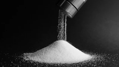 Pouring salt from shaker.