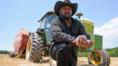 John Boyd Jr. takes a break from bailing hay at his farm in Boydton, Va., May 27, 2021.