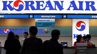 Passengers approach a Korean Air counter at Gimpo airport, Seoul, Oct. 25, 2012.