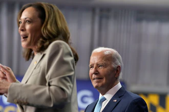 President Joe Biden, right, listens as Democratic presidential nominee Vice President Kamala Harris speaks at Prince George's Community College, Largo, Md., Aug. 15, 2024.