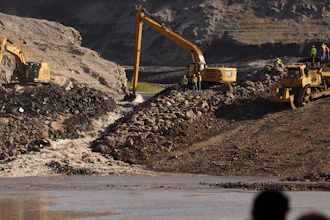 This image provided by Matthew John Mais shows crews working at the Iron Gate cofferdam site along the Klamath River in Siskiyou County, Calif.