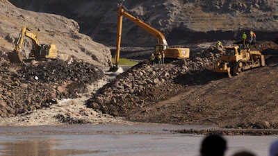 This image provided by Matthew John Mais shows crews working at the Iron Gate cofferdam site along the Klamath River in Siskiyou County, Calif.