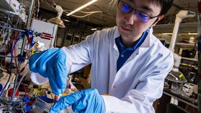 Feng-Yang Chen with the reactor system prototype that is the subject of a new research study published in Nature Catalysis.