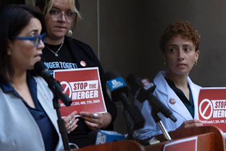 Kim Cordova, President UFCW 7, left, speaks about the Kroger and Albertsons merger before a hearing on the deal.