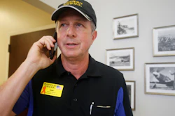 Walt Ehmer, president and CEO of Waffle House, speaks on the phone after landing at the Wilmington, N.C., airport with an emergency response team, Sept. 17, 2018.