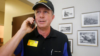 Walt Ehmer, president and CEO of Waffle House, speaks on the phone after landing at the Wilmington, N.C., airport with an emergency response team, Sept. 17, 2018.