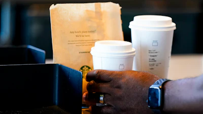 A customer picks up a drink at a Starbucks in Seattle.