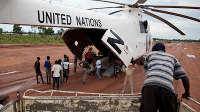 A World Food Programme (WFP) truck backs up to load food items from a recently landed UN helicopter, in Yida camp, South Sudan.