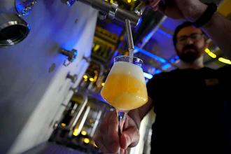 Head Brewmaster Tobias Zollo fills beer at the Weihenstephan brewery in Freising, Germany, Sept. 20, 2024.