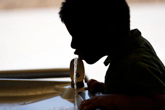 A student drinks from a water fountain at an elementary school in California.