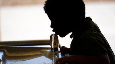 A student drinks from a water fountain at an elementary school in California.