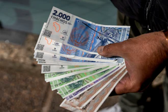 A vendor holds 'chacho' currency at the Exchange Service Center in La Rioja, Argentina, Sept. 13, 2024.