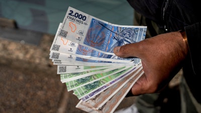 A vendor holds 'chacho' currency at the Exchange Service Center in La Rioja, Argentina, Sept. 13, 2024.