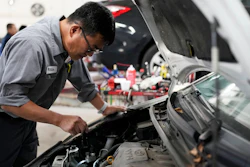 Auto mechanic Willie Chung works on a vehicle at the Express Auto Service Inc., in Chicago, Thursday, Sept. 19, 2024.