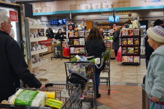 Shoppers wait in line to buy groceries at a Gelson's supermarket, Sherman Oaks, Los Angeles, March 20, 2020.