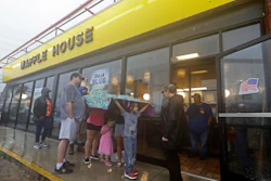 Luke Churchill, left, stands with his wife, Mary, and their children, Katie, 13, Liam, 9, and Raighan, 3, outside a Waffle House in Wilmington, N.C., Sept. 16, 2018.