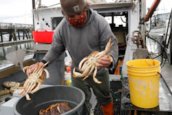 Fisherman Mike Vorak sells Dungeness crabs off his boat at Pillar Point Harbor, Half Moon Bay, Calif., Dec. 29, 2021.