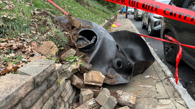 A large metal piece of debris that was flung across a street by a blast at a Louisville, Ky, plant is shown on Wednesday, Nov. 13, 2024. Two workers died in the explosion at the Givaudan Color Sense plant in Louisville.