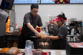 Lawrence Cheng, left, whose family owns seven Wendy's locations south of Los Angeles, works with part-time employee Adriana Ruiz at his Wendy's restaurant in Fountain Valley, Calif., June 20, 2024.