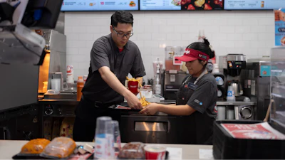 Lawrence Cheng, left, whose family owns seven Wendy's locations south of Los Angeles, works with part-time employee Adriana Ruiz at his Wendy's restaurant in Fountain Valley, Calif., June 20, 2024.