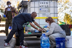 Volunteers with BeLoved Asheville fill bottles of drinking water, Asheville, N.C., Oct. 8, 2024.