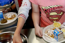 Students line up for lunch at a middle school in Sandy, Utah, May 19, 2017.