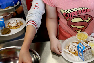 Students line up for lunch at a middle school in Sandy, Utah, May 19, 2017.