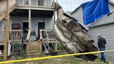 A massive piece of debris that flew from the Givaudan Color Sense plant after an explosion is pictured on Wednesday, Nov. 13, 2024 in Louisville, Ky.