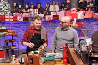 This image released by The Food Network shows Bobby Flay, left, and Michael Symon during an episode of the cooking series 'Beat Bobby Flay: Holiday Throwdown.'