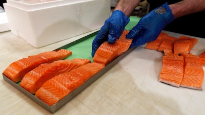 Canadian certified organic farm-raised King Salmon filets are placed on a tray in a store in Fairfax, Va., April 10, 2015.