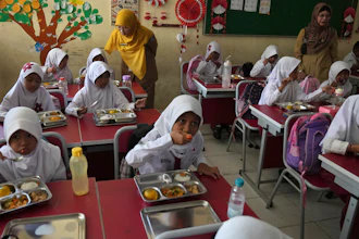 Students eat at the kickoff of an ambitious government meal program, Depok, Indonesia, Jan. 6, 2025.