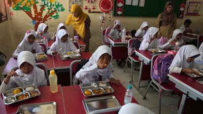 Students eat at the kickoff of an ambitious government meal program, Depok, Indonesia, Jan. 6, 2025.