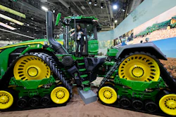 A convention goer exits a John Deere 9RX Tractor at the John Deere booth during the CES tech show, Las Vegas, Jan. 7, 2025.