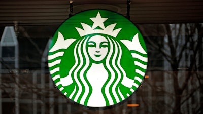 A Starbucks logo sign in the window of one of the chain's cafes in Pittsburgh, Jan. 12, 2017.