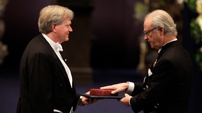 The 2011 Nobel Prize Laureate for Physics Dr Brian P. Schmidt from Australia receives his Nobel Prize from Sweden's King Carl XVI Gustaf, right, during the Nobel Prize award ceremony at the Stockholm Concert Hall in Stockholm, Sweden, Dec. 10, 2011.