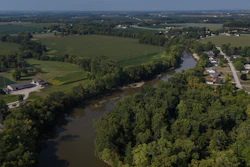 Water flows down the Sandusky River between farms, Fremont, Ohio, Aug. 26, 2024.