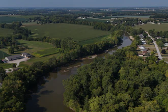 Water flows down the Sandusky River between farms, Fremont, Ohio, Aug. 26, 2024.