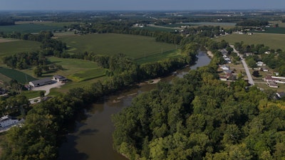 Water flows down the Sandusky River between farms, Fremont, Ohio, Aug. 26, 2024.