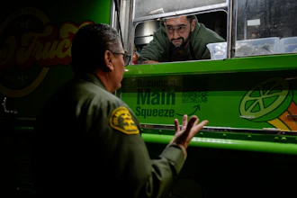 World Central Kitchen Chef Corp member Daniel Shemtob talks with an Eaton Fire first responder as he serves burritos from his food truck, The Lime Truck, at the Rose Bowl Stadium, Pasadena, Calif., Jan. 15, 2025.