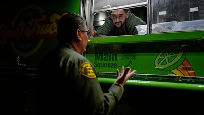 World Central Kitchen Chef Corp member Daniel Shemtob talks with an Eaton Fire first responder as he serves burritos from his food truck, The Lime Truck, at the Rose Bowl Stadium, Pasadena, Calif., Jan. 15, 2025.