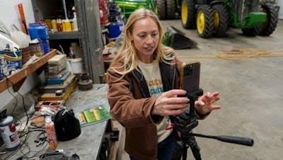 Zoe Kent prepares to create a social media video at her farm in Bucyrus, Ohio, Jan. 20, 2025.
