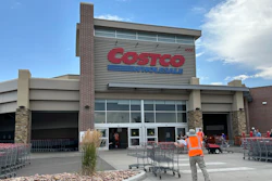 A cart wrangler gathers shopping carts outside a Costco warehouse in Sheridan, Colo., July 16, 2024.