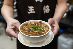 A waiter holds a bowl of snake soup at a restaurant in Hong Kong, Jan. 6, 2025.