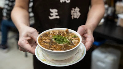 A waiter holds a bowl of snake soup at a restaurant in Hong Kong, Jan. 6, 2025.